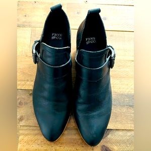Black leather booties with silver buckle on side